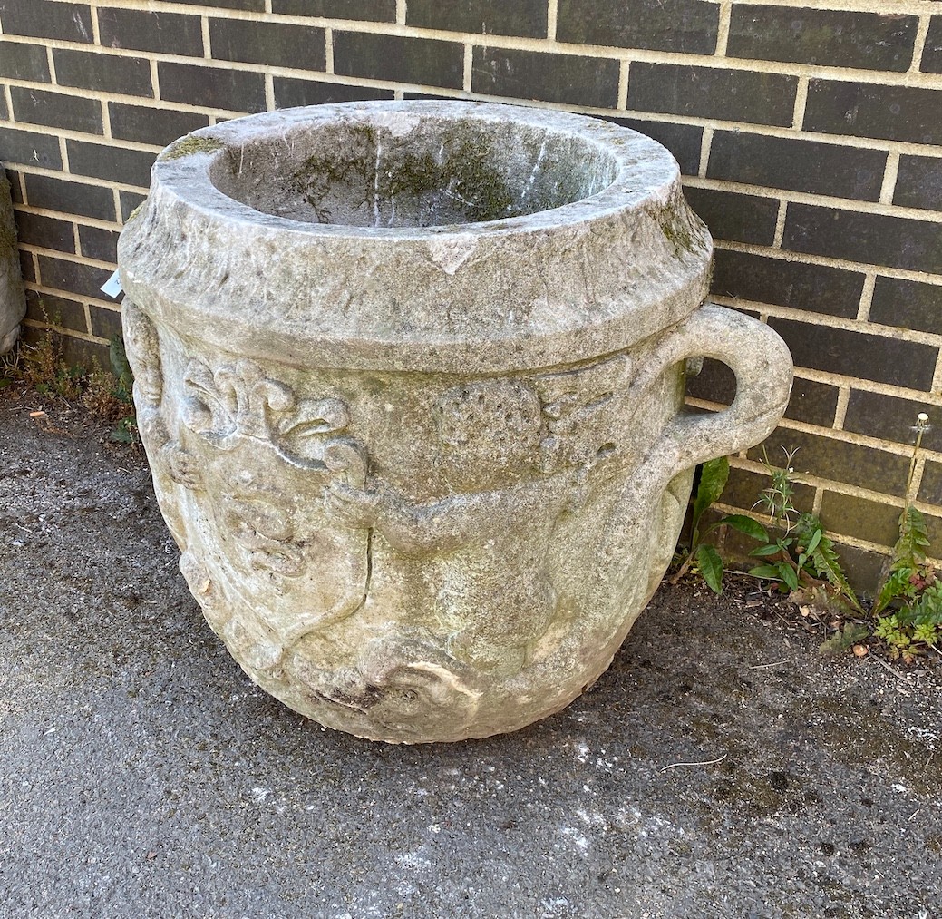 A large circular reconstituted stone garden planter with moulded serpent armorial, diameter 66cm, height 66cm